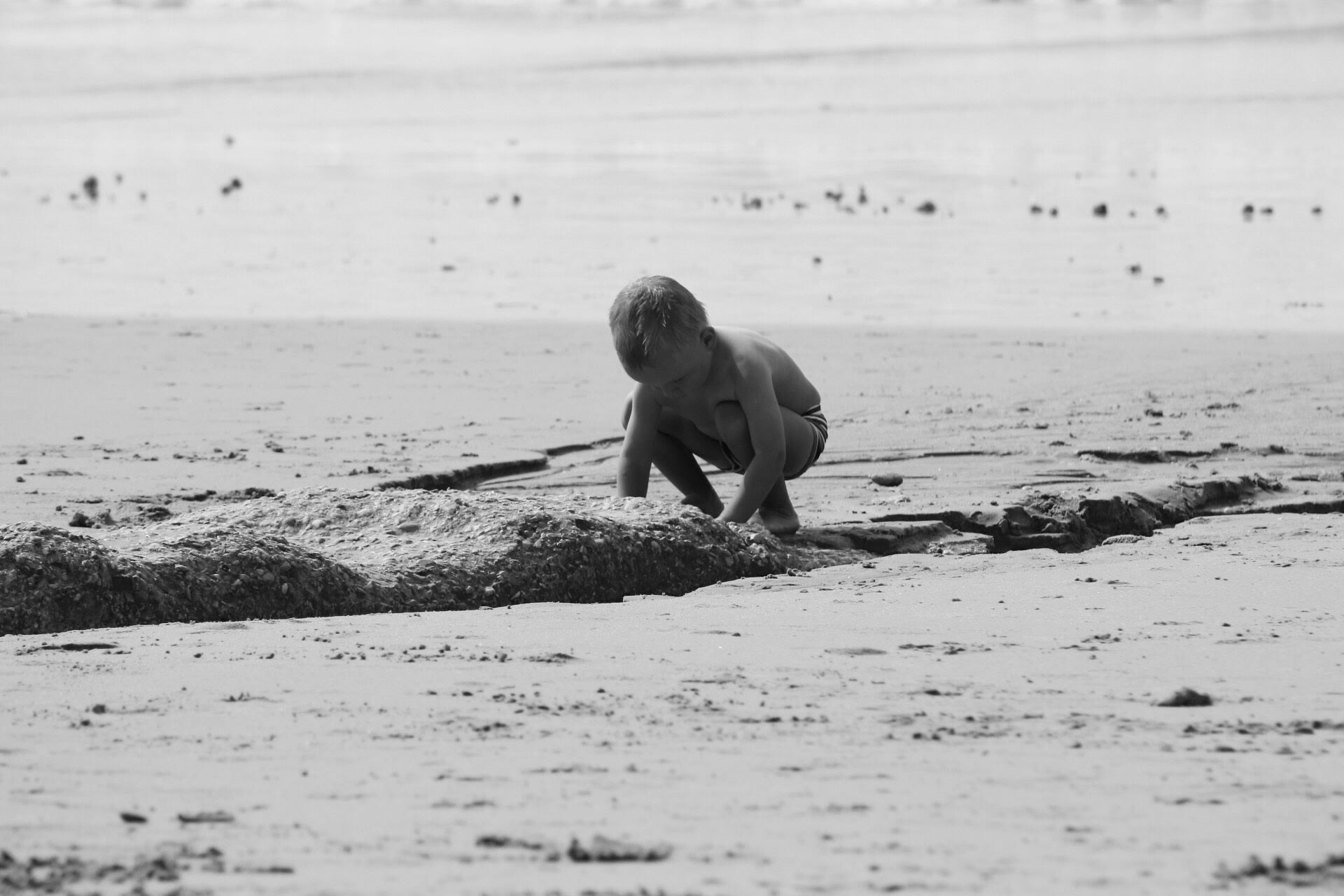 little boy investigating the beach