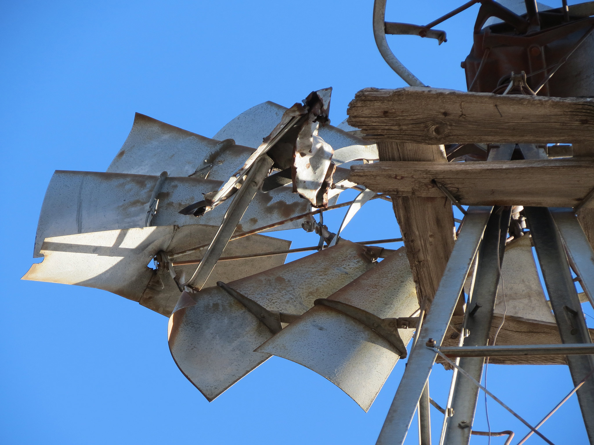 view of the underside of an old-fashioned windmill that's seen better days