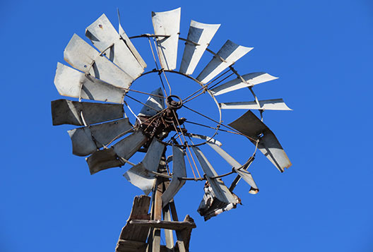 Old beat up windmill photo